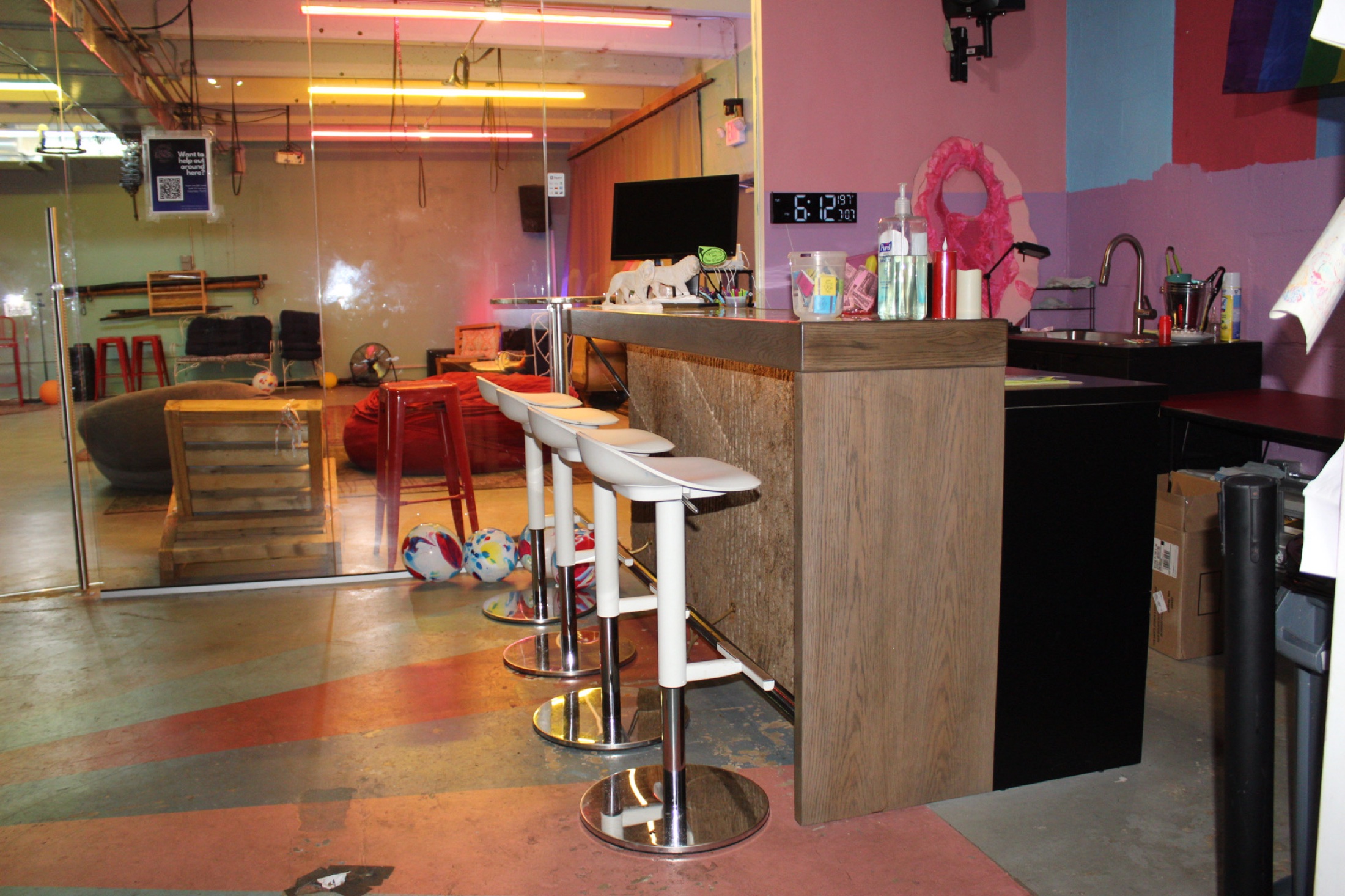 The Dear Eleanor bar area with stools and colorful walls