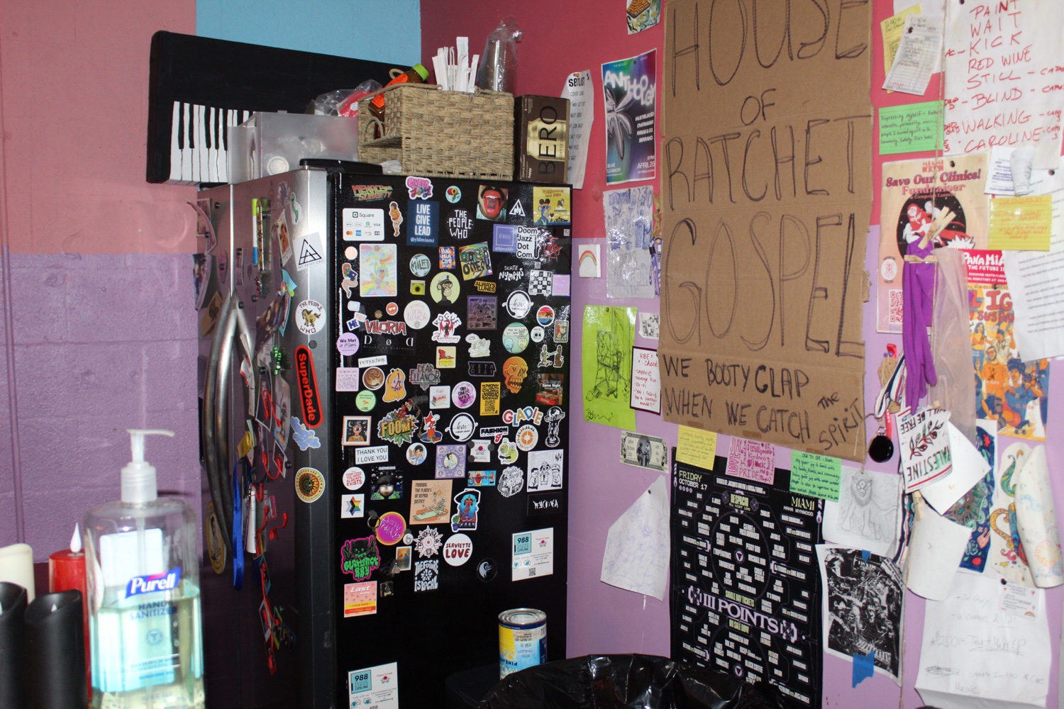 Flyers, stickers, and community notes on the Dear Eleanor wall